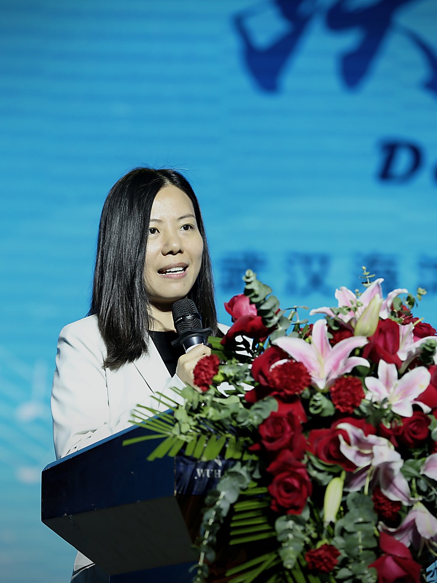 Candy Tang speaking at a podium