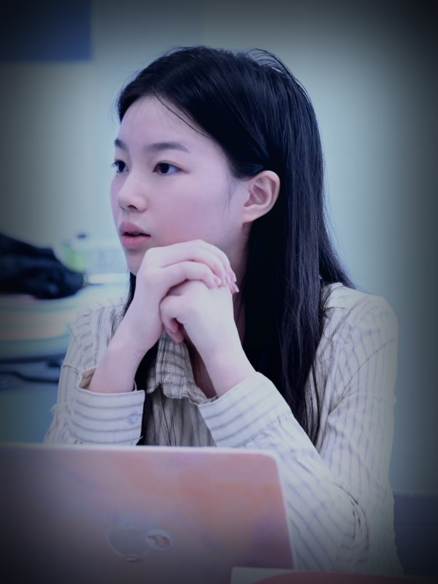 Stephanie Liu in discussion during a debate event